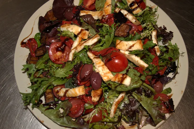 Salad of grilled halloumi, olives, cherry tomatoes and mixed leaves