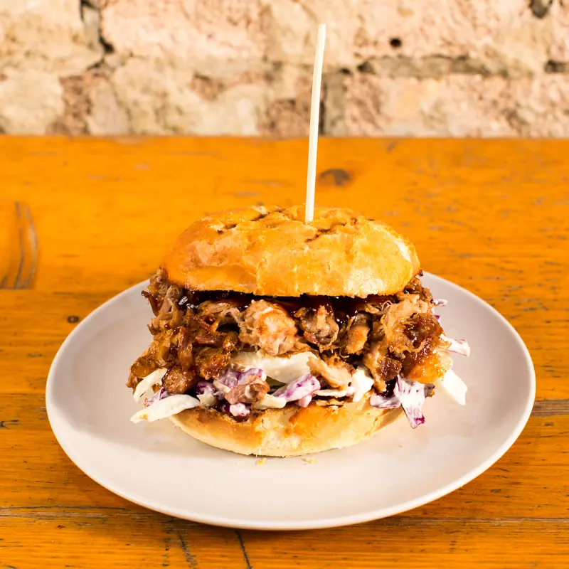 Pulled pork burger with coleslaw and BBQ sauce